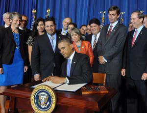 President Obama signs the proclamation for the Organ Mountains-Desert Peaks National Monument. Behind him are Interior Secretary Sally Jewell (blue dress) and New Mexico Democratic Reps. Ben Ray Luján and Michelle Lujan Grisham and Sens. Martin Heinrich and Tom Udall. White House photo.