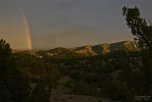 Monsoon rainbow behind the Sandia Mountains near Albuquerque, N.M. Photo © William P. Diven