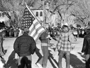 War protester Gary Werner marches in parallel with ROTC cadets. New Mexico State University, early 1970. Photo © William P. Diven.