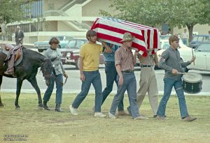 War protesters, one of them an Air Force ROTC cadet, mimic a funeral procession leading to a 1971 rally at New Mexico State University. Photo © William P. Diven.