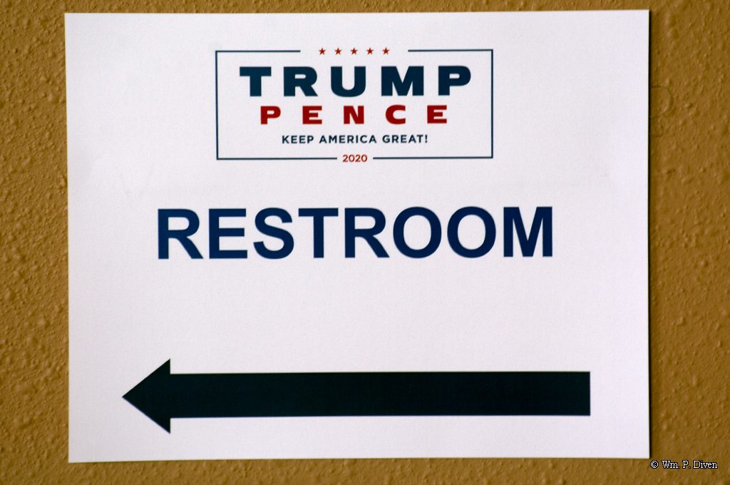 A campaign-branded restroom sign at the Santa Ana Star Center points to relief. © William P. Diven